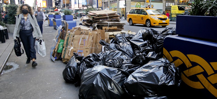Trash bags are piled up on a Manhattan street.