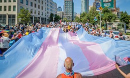 People unfold a giant trans flag at the Queer Liberation March in New York City in 2022.