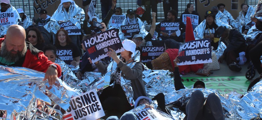 Die-in demonstration by organizers and housing advocates on the steps of the U.S. Supreme Court as oral arguments are heard in Grants Pass v. Johnson on April 22, 2024.