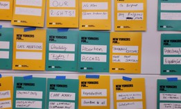 Supporters of the state Equal Rights Amendment hang up posters during an organizing event.