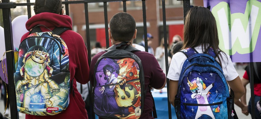 Students look through the fence at P.S. 25 in the Bronx.