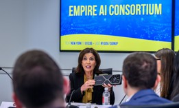 Gov. Kathy Hochul shows off an nVidia RTX 3080 Ti graphics card, which is commonly used in artificial intelligence data centers. The governor announced a $275 million state investment into building an artificial intelligence computing center at the University of Buffalo.