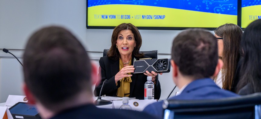 Gov. Kathy Hochul shows off an nVidia RTX 3080 Ti graphics card, which is commonly used in artificial intelligence data centers. The governor announced a $275 million state investment into building an artificial intelligence computing center at the University of Buffalo.