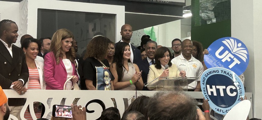 From left, Joshua Clennon, City Council Members Pierina Sanchez and Julie Menin, Assembly Member Yudelka Tapia, City Council Speaker Adrienne Adams, state Sen. Jessica Ramos, Rep. Adriano Espaillat, Gov. Kathy Hochul and Mayor Eric Adams.