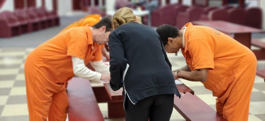 People detained in Ulster County Jail fill out voter registration forms and absentee ballots.