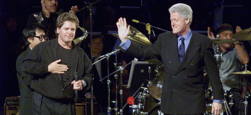 Roger Clinton Jr., left, brother of former President Bill Clinton, right, performs with his band in South Korea in 1998.