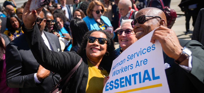 New York City Mayor Eric Adams poses for a selfie with attendees at a rally announcing the $741 million investment for an estimated 80,000 human services workers employed by non-profit organizations with a city contract as part of a new cost-of-living adjustment on March 14, 2024.