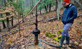 Mike Hastings surveys one of the uncapped wells on his property in Western New York.