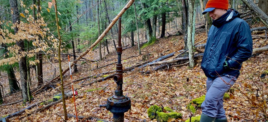 Mike Hastings surveys one of the uncapped wells on his property in Western New York.