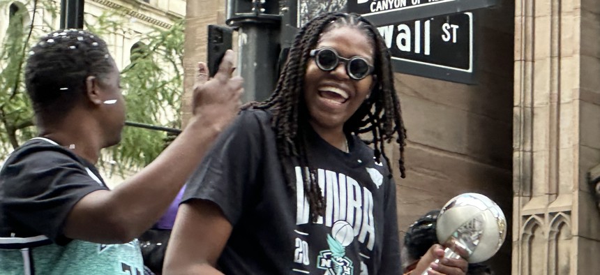 WNBA Finals MVP Jonquel Jones of the New York Liberty celebrates the team’s championship victory from atop a parade float along the Canyon of Heroes in Lower Manhattan on Thursday. 