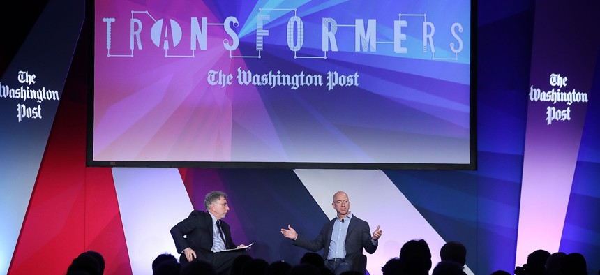 Washington Post owner Jeff Bezos, right, is interviewed by the paper’s then-editor Marty Baron, left, on May 18, 2016.