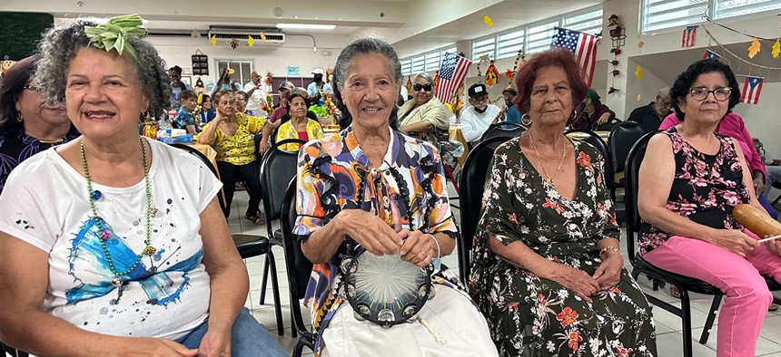 Residents at Centro Esperanza Para La Vejez, an assisted living facility in Carolina, Puerto Rico, sit in the front row at a Somos conference “day of service,” singing along with volunteers to the tune, “Besame Mucho.”