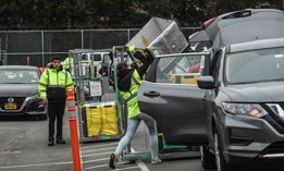 A worker is seen outside of an Amazon distribution center in Queens on Dec. 16, 2019.