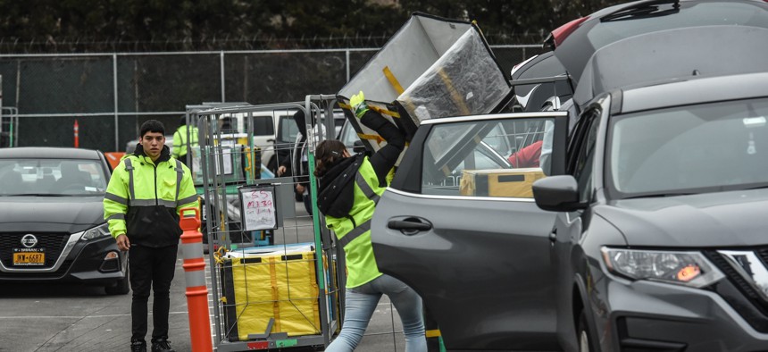 A worker is seen outside of an Amazon distribution center in Queens on Dec. 16, 2019.