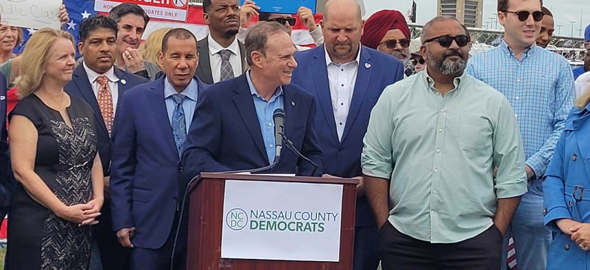 State Democratic Party Chair Jay Jacobs, center, and state Sen. Kevin Thomas, right, attend a protest outside of a Trump rally on Long Island in September 2024.