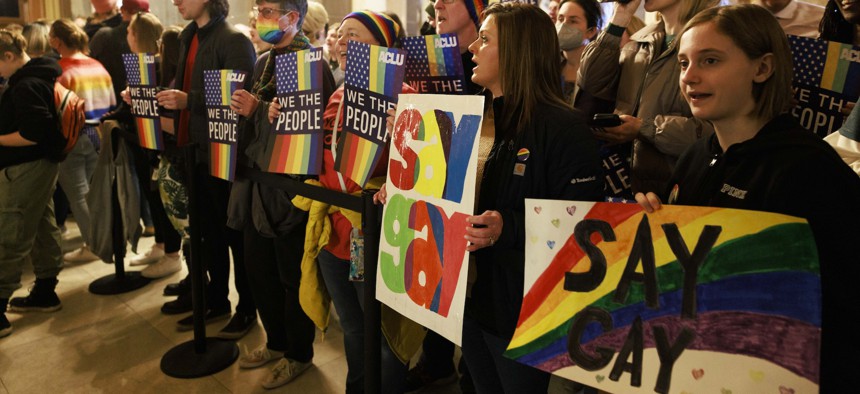 Protesters hold placards while demonstrating against Indiana’s “Don’t Say Gay” bill on March 20, 2023.