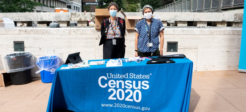 U.S. Census workers stand outside Lincoln Center on Sept. 24, 2020.