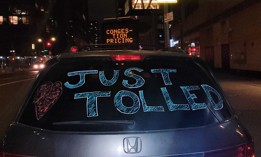 A festive minivan adorned with the words “Just Tolled” drove across 61st Street just after the new congestion pricing program went into effect at midnight on Jan. 5, 2024.