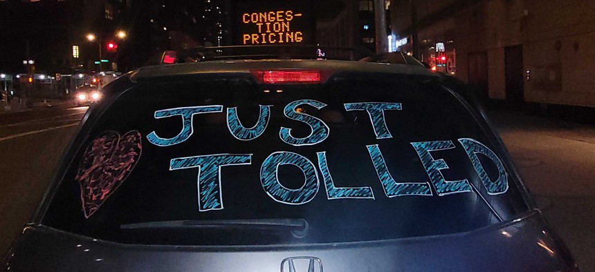 A festive minivan adorned with the words “Just Tolled” drove across 61st Street just after the new congestion pricing program went into effect at midnight on Jan. 5, 2024.