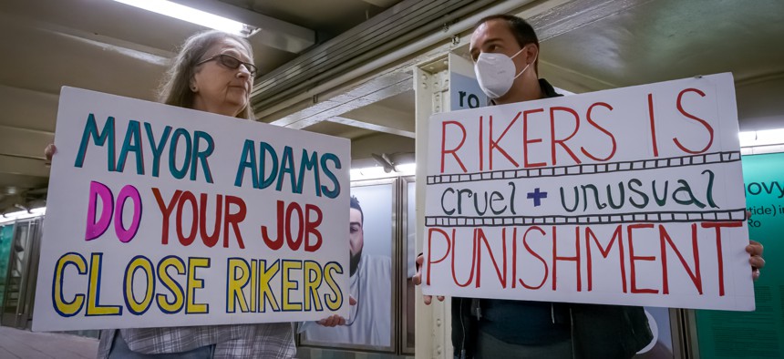 Protesters hold signs calling on Mayor Eric Adams to close the Rikers Island jails complex on April 3, 2023.