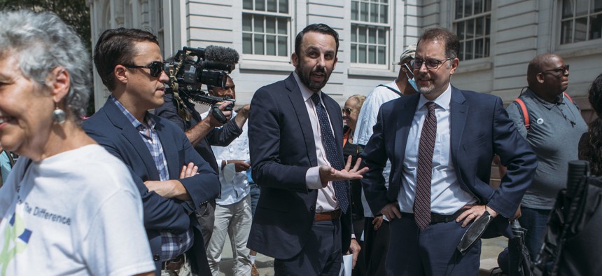 Council Member Keith Powers, center, speaks with Manhattan Borough President Mark Levine, right, outside City Hall in 2022. 