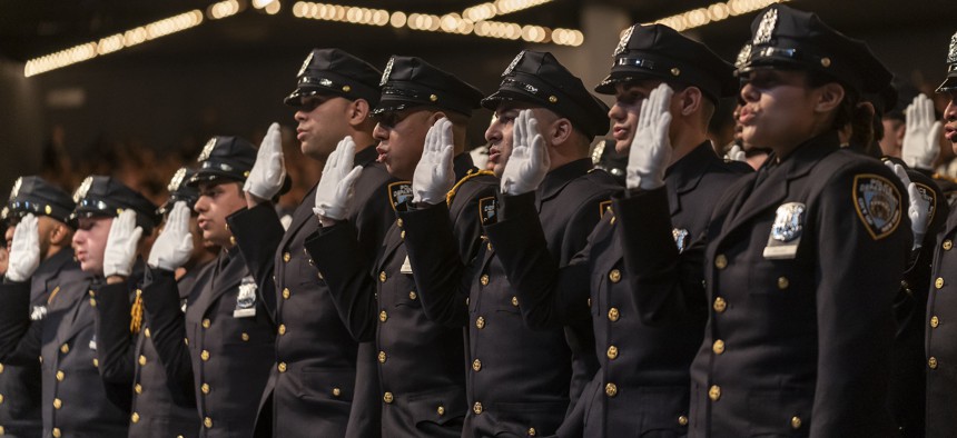 New police officers take an oath during a New York City Police Department graduation ceremony at Madison Square Garden.