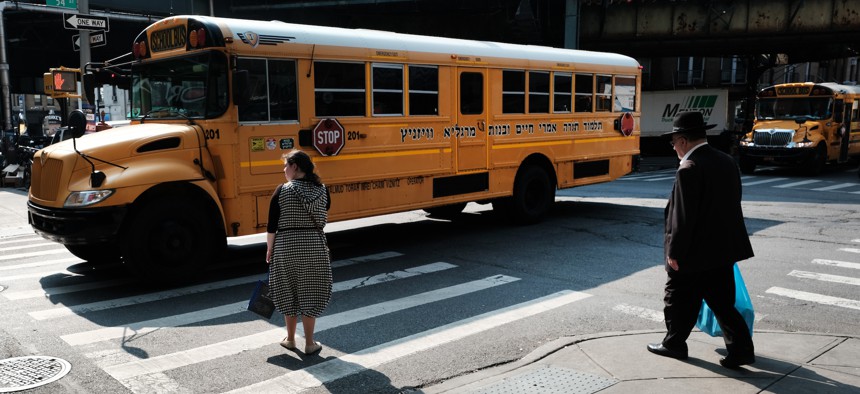 A yeshiva bus drives through the Borough Park neighborhood of Brooklyn on Sept. 12, 2022.