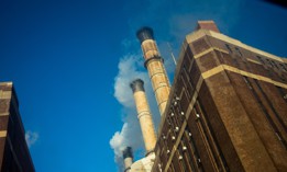 Smoke and condensation flow out of smokestacks at a power plant in Manhattan.