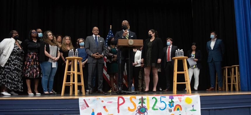 Mayor Eric Adams, center, and Schools Chancellor David Banks, left, announce a comprehensive approach to supporting students with dyslexia at P.S. 125 in Harlem on May 12, 2022.