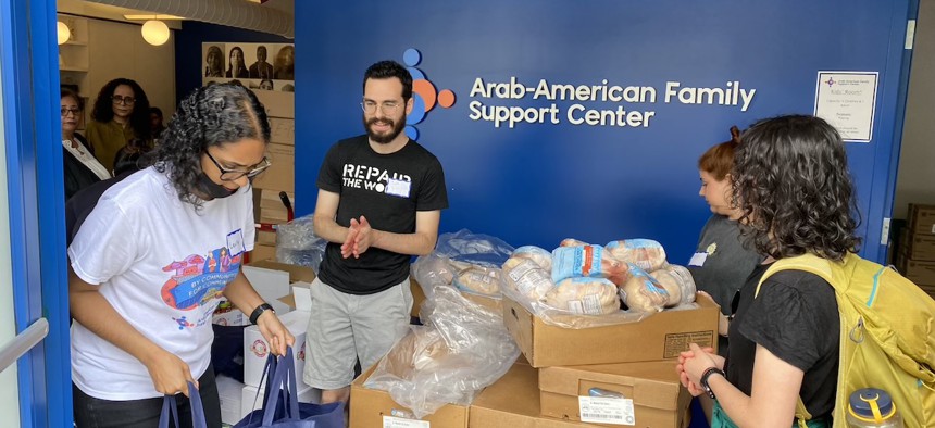 Staff and volunteers prepare to distribute food to clients of the Arab American Family Support Center from their Brooklyn location