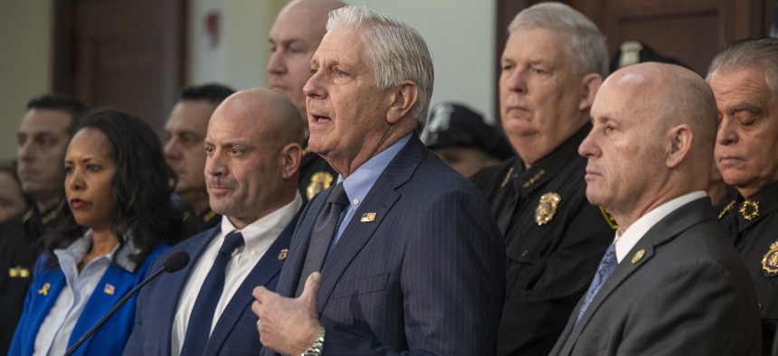 Nassau County Executive Bruce Blakeman, center, announces new ICE enforcement measures, flanked by ICE Special Agent Brian Flanagan, left, and Nassau County Police Commissioner Patrick Ryder, right, on Feb. 4, 2025.