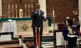 Rep. Adriano Espaillat with a mic in hand moderating a Know Your Rights workshop at Our Ladies of Angels Catholic Church in the Bronx.