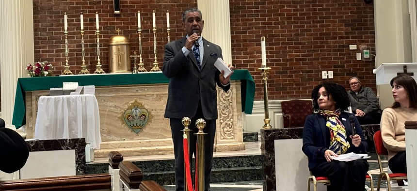 Rep. Adriano Espaillat with a mic in hand moderating a Know Your Rights workshop at Our Ladies of Angels Catholic Church in the Bronx.