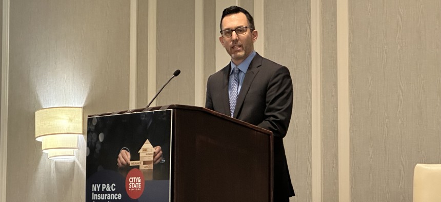 Travis Wattie, assistant vice president of government relations at Big I New York, delivers remarks at the New York P&C Insurance Summit in Albany Tuesday. 