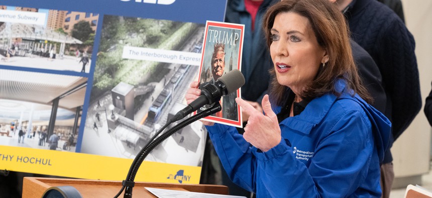 Gov. Kathy Hochul points to a fake Time magazine cover depicting President Donald Trump during a press conference on Feb. 19, 2025.