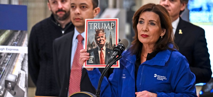 Gov. Kathy Hochul holds a mock version of Time magazine’s “Person of the Year” issue, proclaiming Donald Trump “King of New York” at a press conference at Grand Central Terminal Wednesday. 