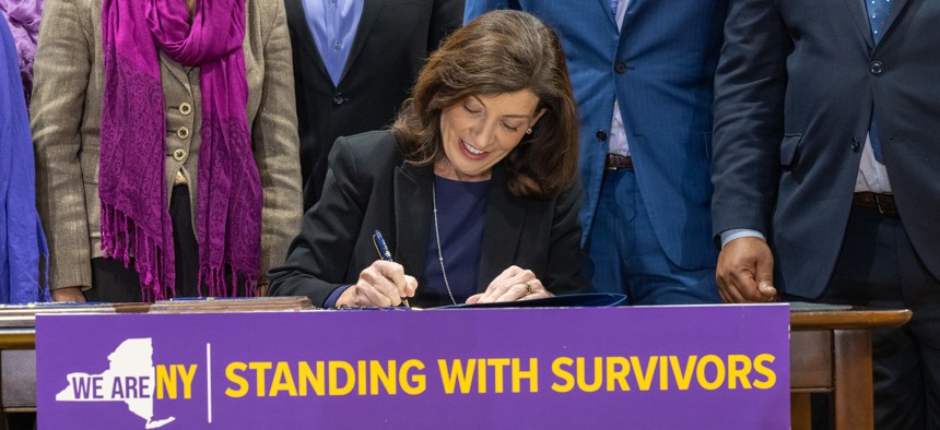 Gov. Kathy Hochul signs into law a package of bills to strengthen protections for survivors of domestic and gender-based violence on Oct. 18, 2022.