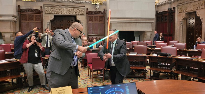State Sens. Gustavo Rivera and George Borrello engage in a lightsaber duel in the Senate chamber on May 19, 2025.