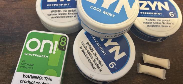 A collection of tins containing nicotine pouches.