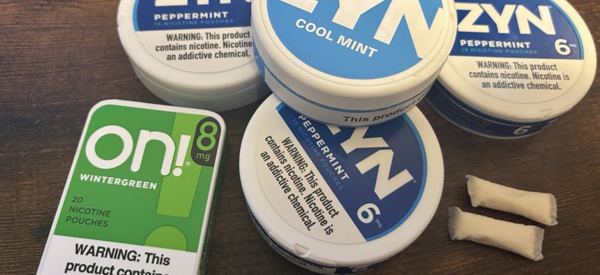 A collection of tins containing nicotine pouches.