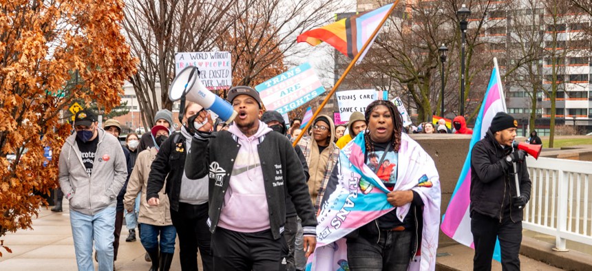 Brittan Hardgers, holding the blue megaphone, leading a group in the Rochester 2025 Trans Visibility March.
