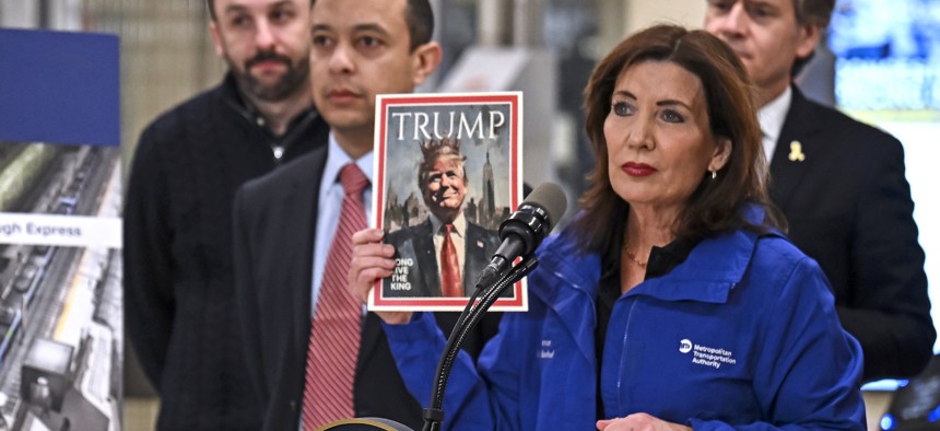 Gov. Kathy Hochul holds up a fake magazine cover depicting President Donald Trump as a king during a press conference about congestion pricing on Feb. 19, 2025.