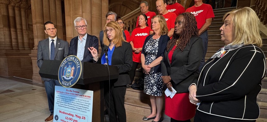 Assembly Member Linda Rosenthal, center, and state Sen. Cordell Cleare, second from right, are sponsoring a bill that would allow survivors to discharge coerced debt.