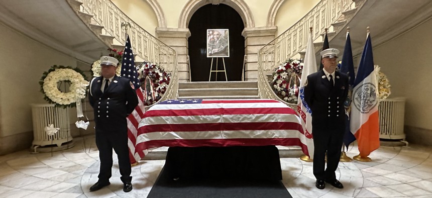 Uniformed New York CIty Fire Department personnel stand watch over former Rep. Charles Rangel’s casket at City Hall on Thursday.