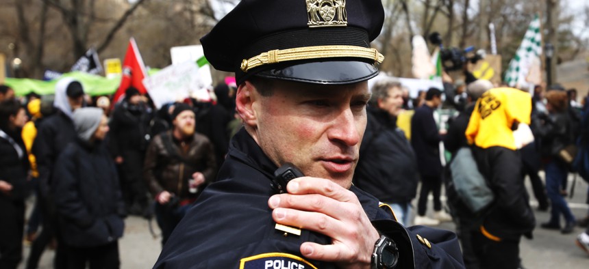 An NYPD officer communicates on his radio.