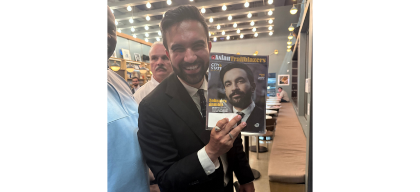 Presumptive New York City Democratic mayoral nominee Zohran Mamdani poses with a copy of City & State before leaving his primary election night victory party in the early morning hours of June 25.