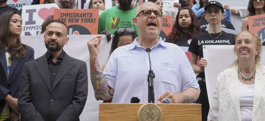 New York City Council Member Justin Brannan speaks at a rally in support of increased funding for immigrant legal services.