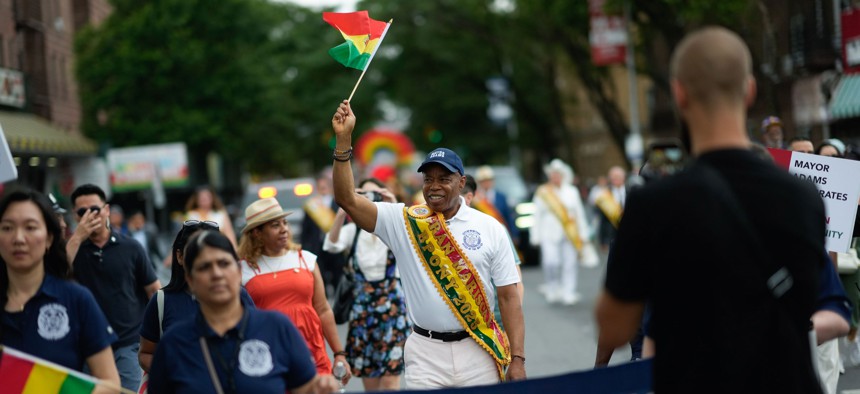 Mayor Eric Adams, pictured here marching in the Bolivian Day Parade, raised more than anyone else in the latest mayoral fundraising cycle.