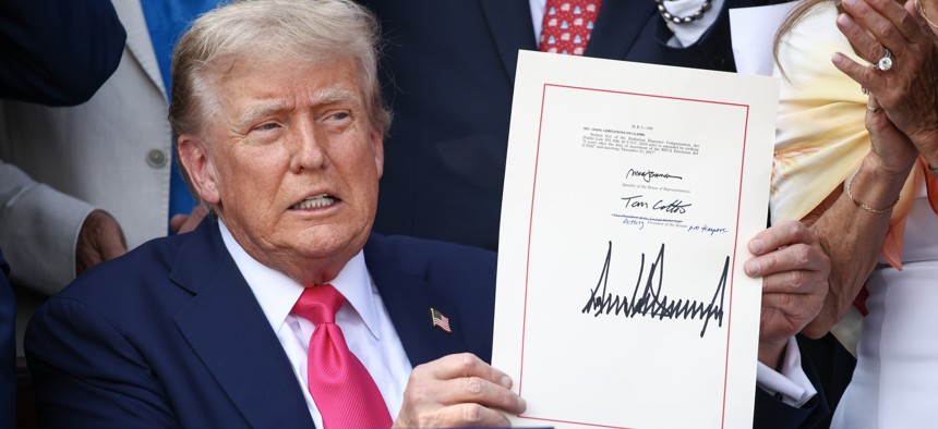 President Donald Trump, joined by Republican lawmakers, signs the One, Big Beautiful Bill Act into law during an Independence Day military family picnic on the South Lawn of the White House on July 04, 2025 in Washington, D.C.