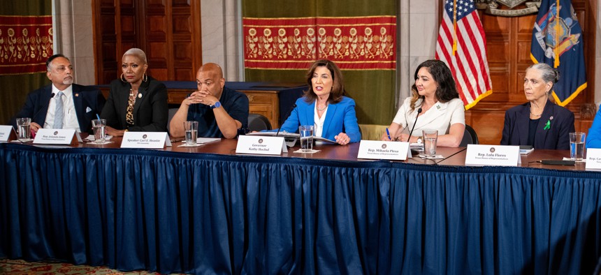 Gov. Kathy Hochul, center, holds a press conference with Assembly Speaker Carl Heastie and Texas state lawmakers.